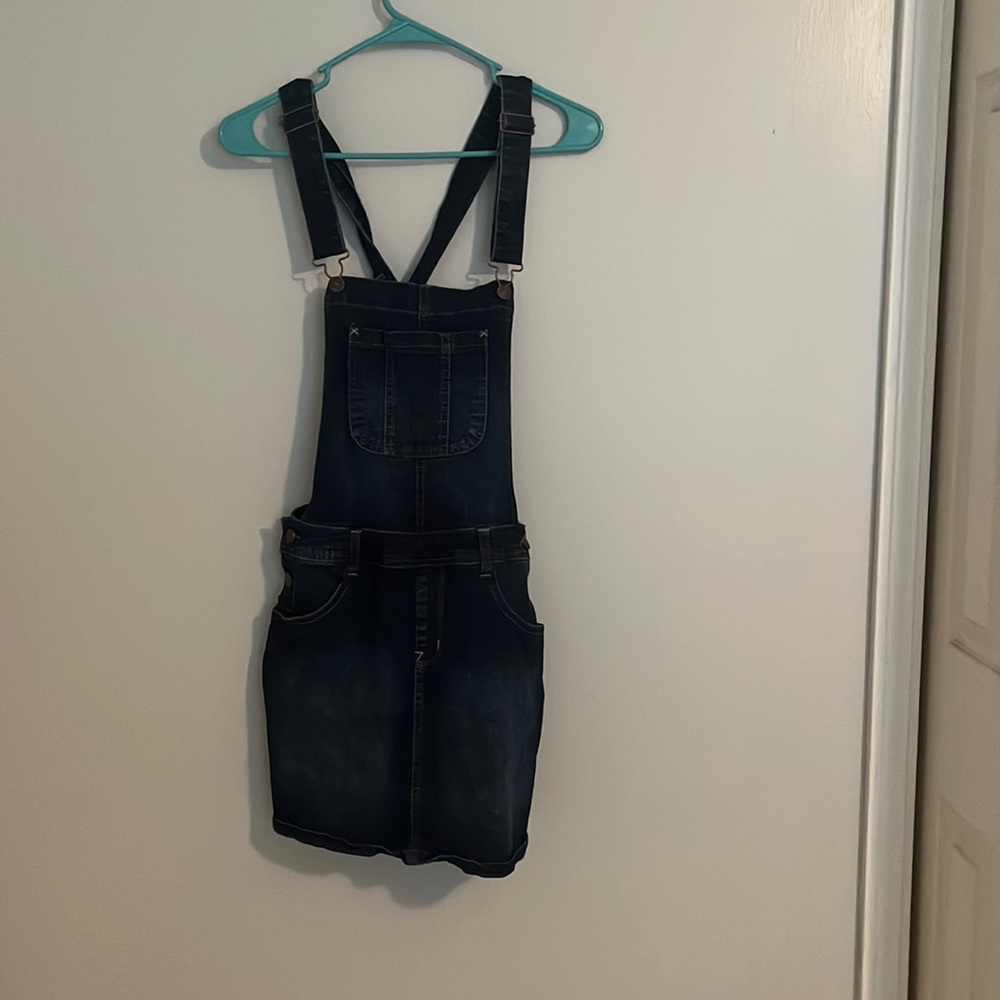 Denim overalls. The bottoms are a skirt. Super cute and adjustable straps.